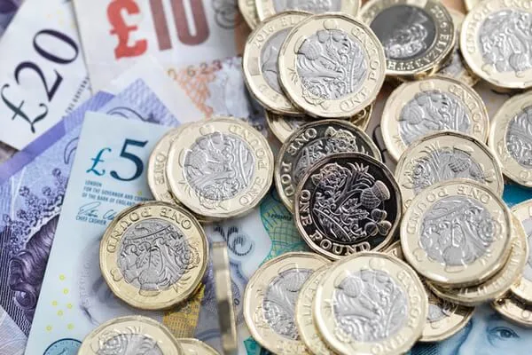 British bank notes and coins, representing the low cost of selling a house at auction