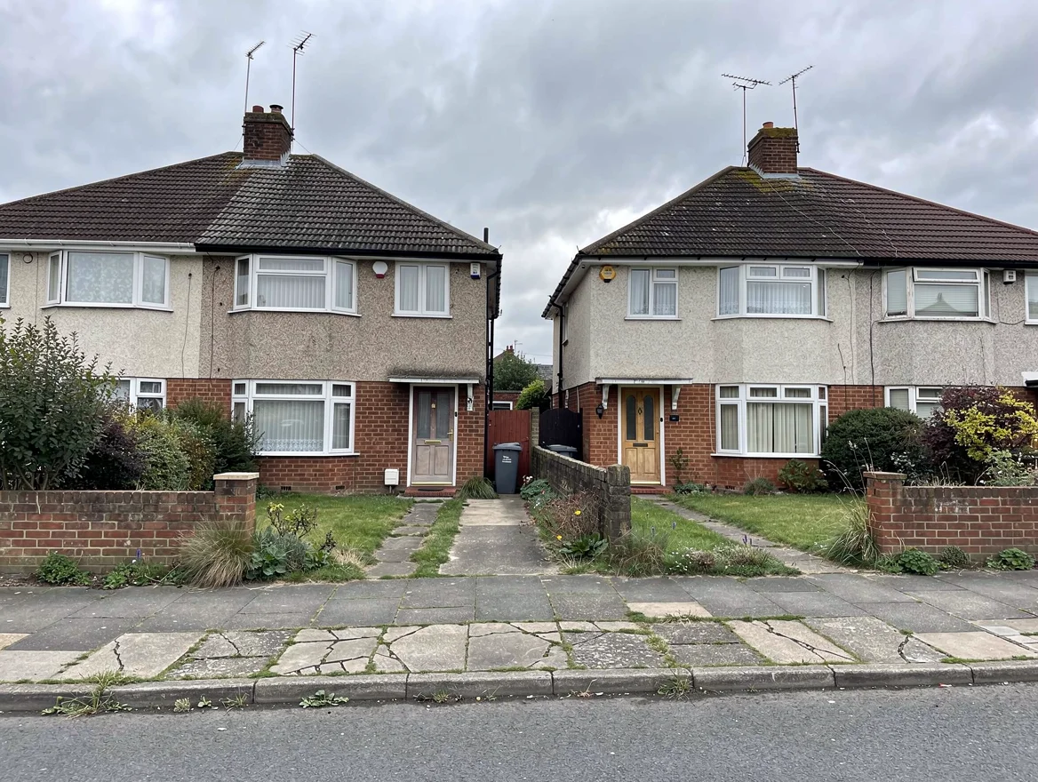 Pair of 1930s pebbledash Becontree-estate ex-council semi-detached houses in Dagenham, east London, typical of the properties sold at auction in the area