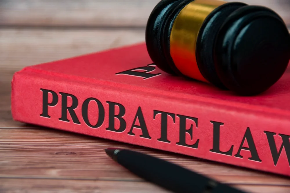 A red 'Probate Law' book with a judge's gavel resting on top