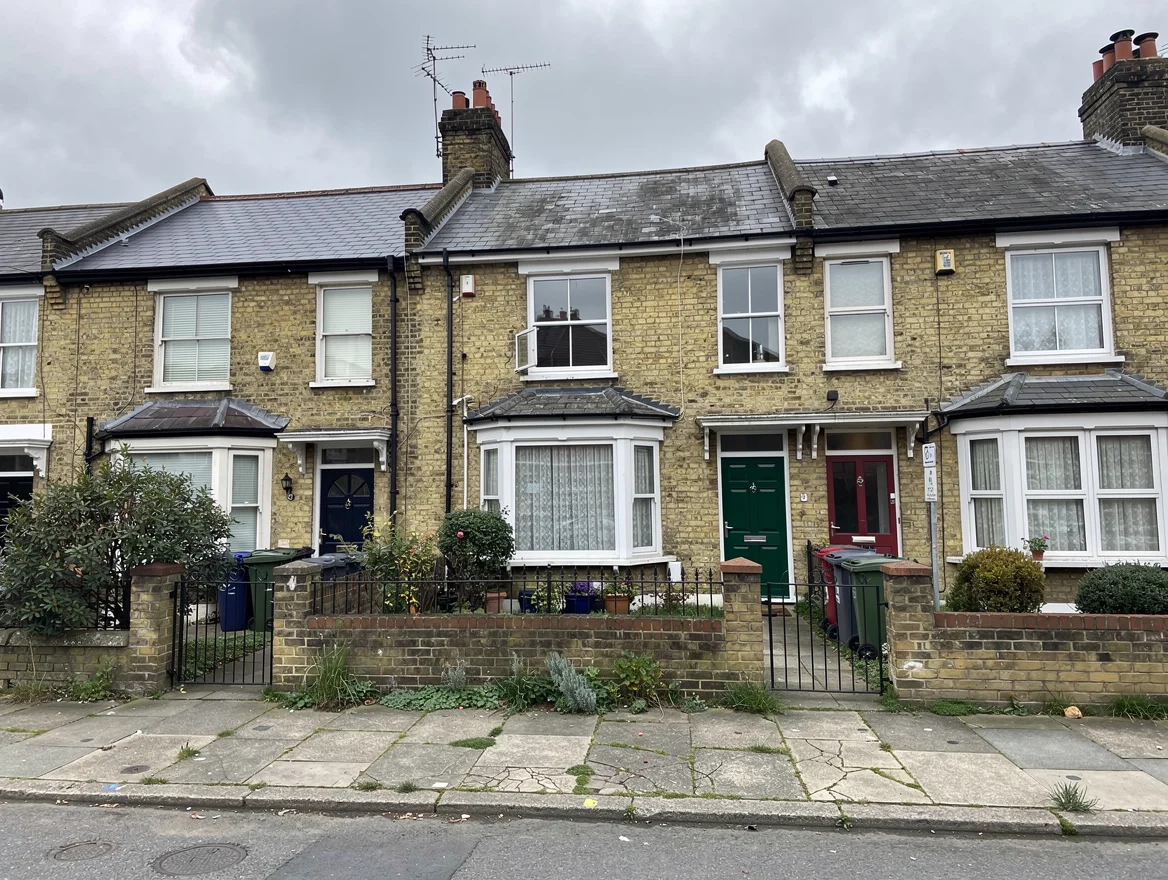 Row of Edwardian yellow-brick terraced houses on a quiet Newham street, typical of the East London properties sold at auction