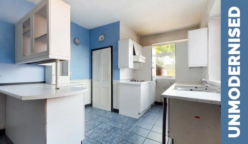 The dated, basic kitchen of an unmodernised British property being sold at auction